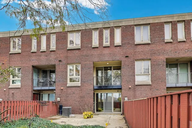 a front view of a brick house with many windows