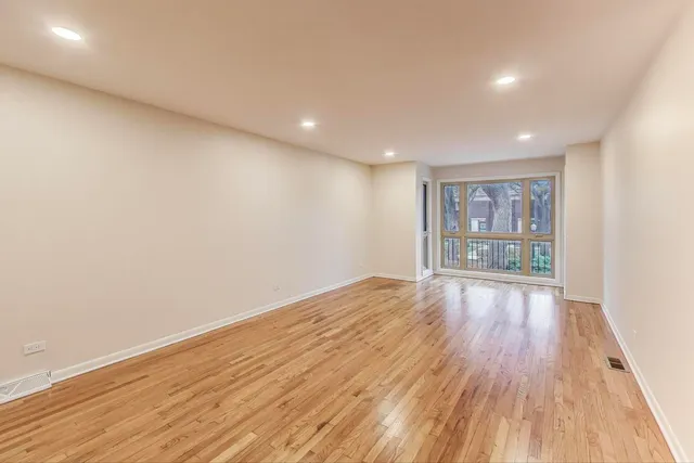 a view of wooden floor and windows in a room
