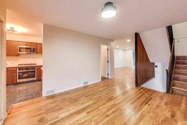 a view of a kitchen with a sink and a refrigerator