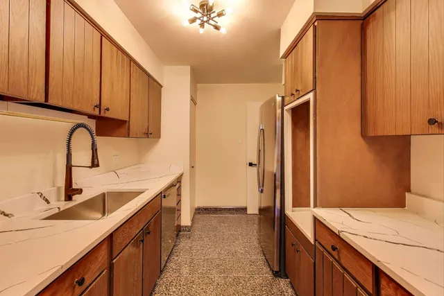 a kitchen with a sink and a refrigerator