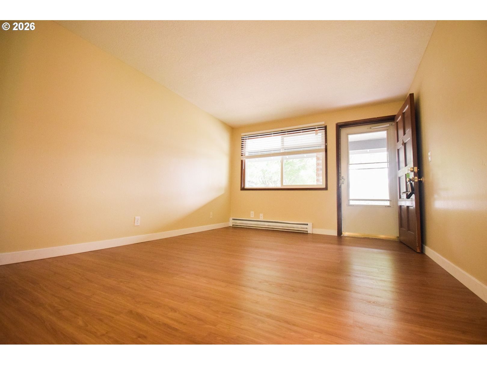 3124 19th Place Forest Grove, OR 97116 - Photo 12 of 31 a view of an empty room with wooden floor and a window