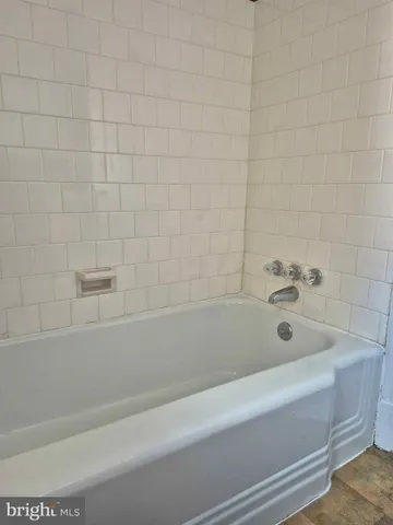 a bathroom with a bathtub and shower