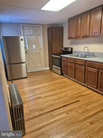 a kitchen with stainless steel appliances granite countertop a refrigerator sink and cabinets