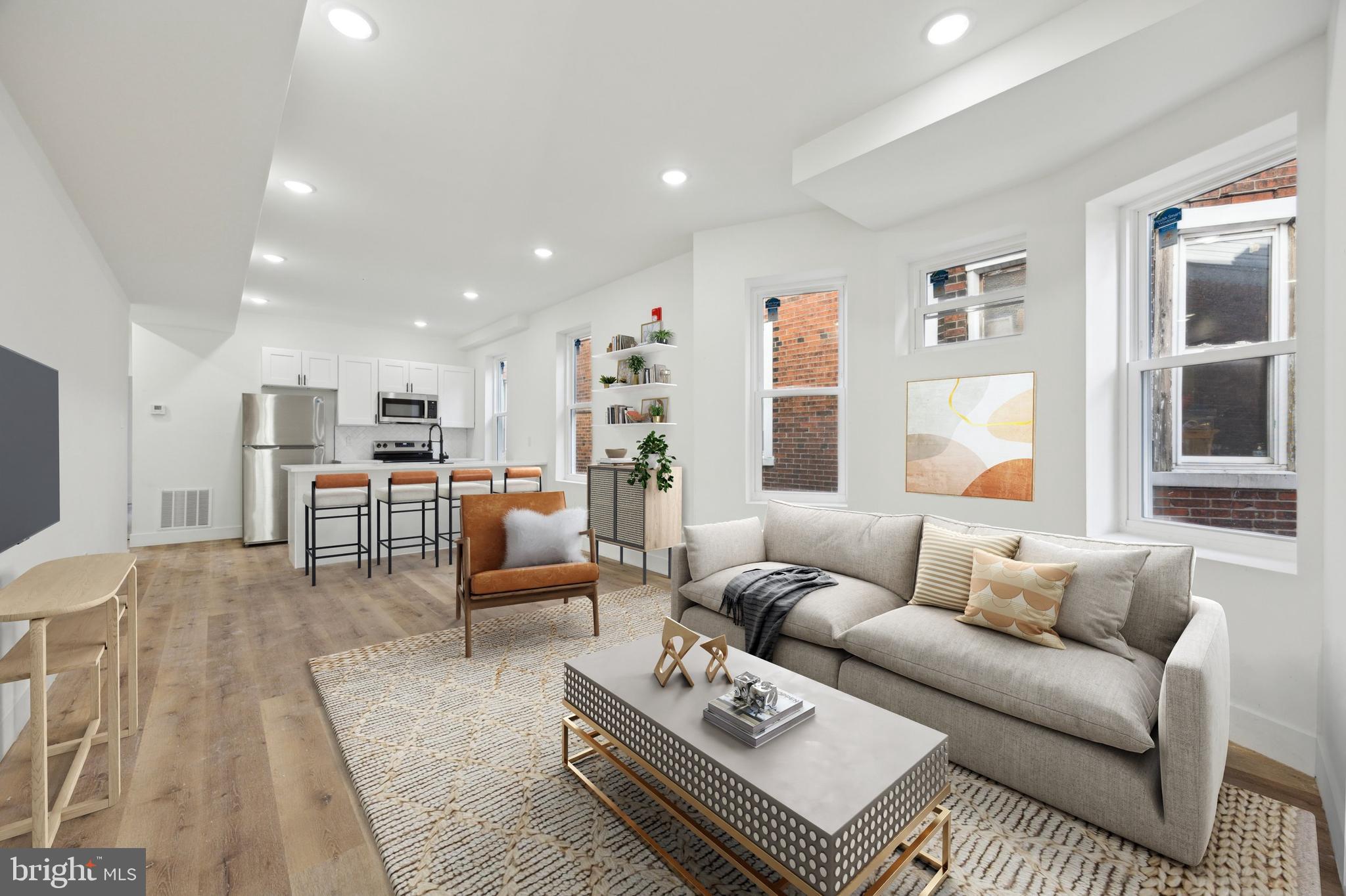a living room with furniture and kitchen view