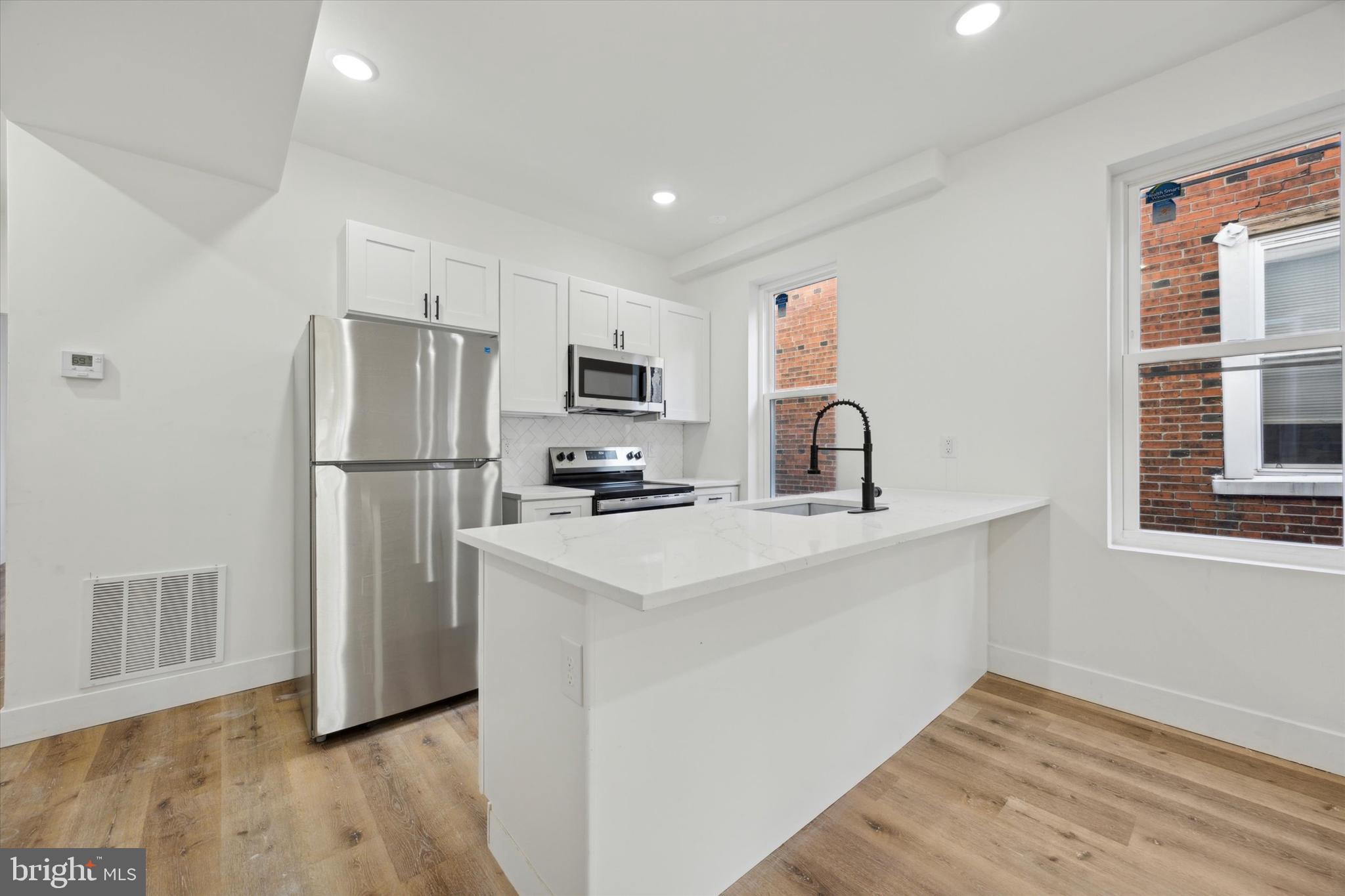 5325 Baltimore Avenue, Unit 2 Philadelphia, PA 19143 - Photo 13 of 25 a kitchen with a refrigerator sink and cabinets