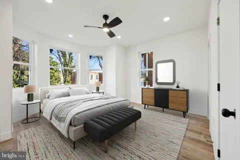 a bedroom with a large bed and a dresser