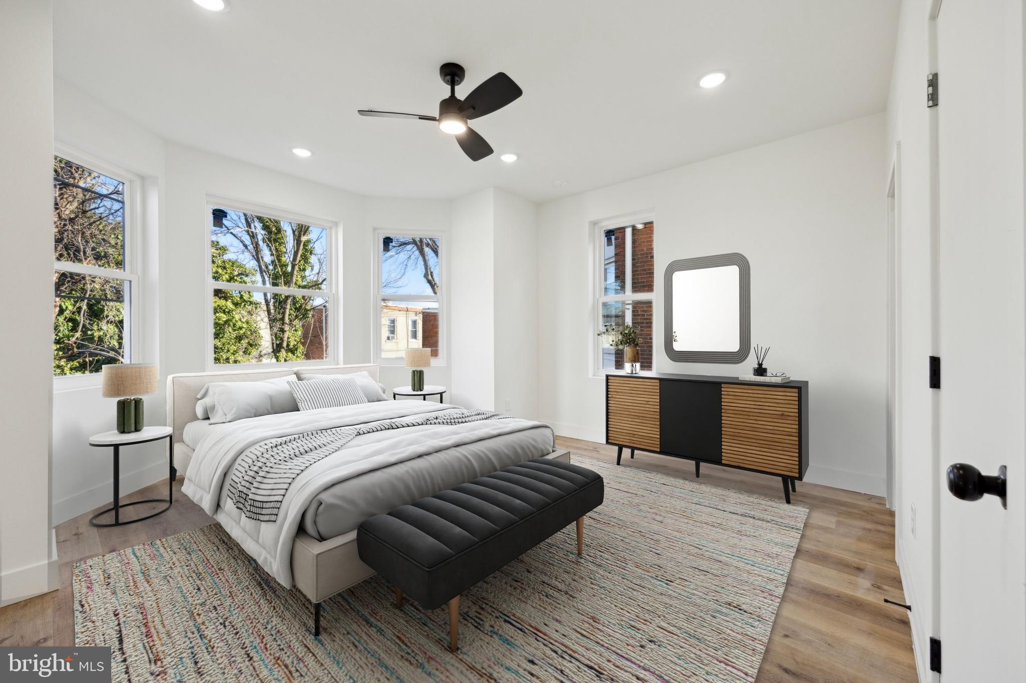 5325 Baltimore Avenue, Unit 2 Philadelphia, PA 19143 - Photo 14 of 25 a bedroom with a large bed and a dresser