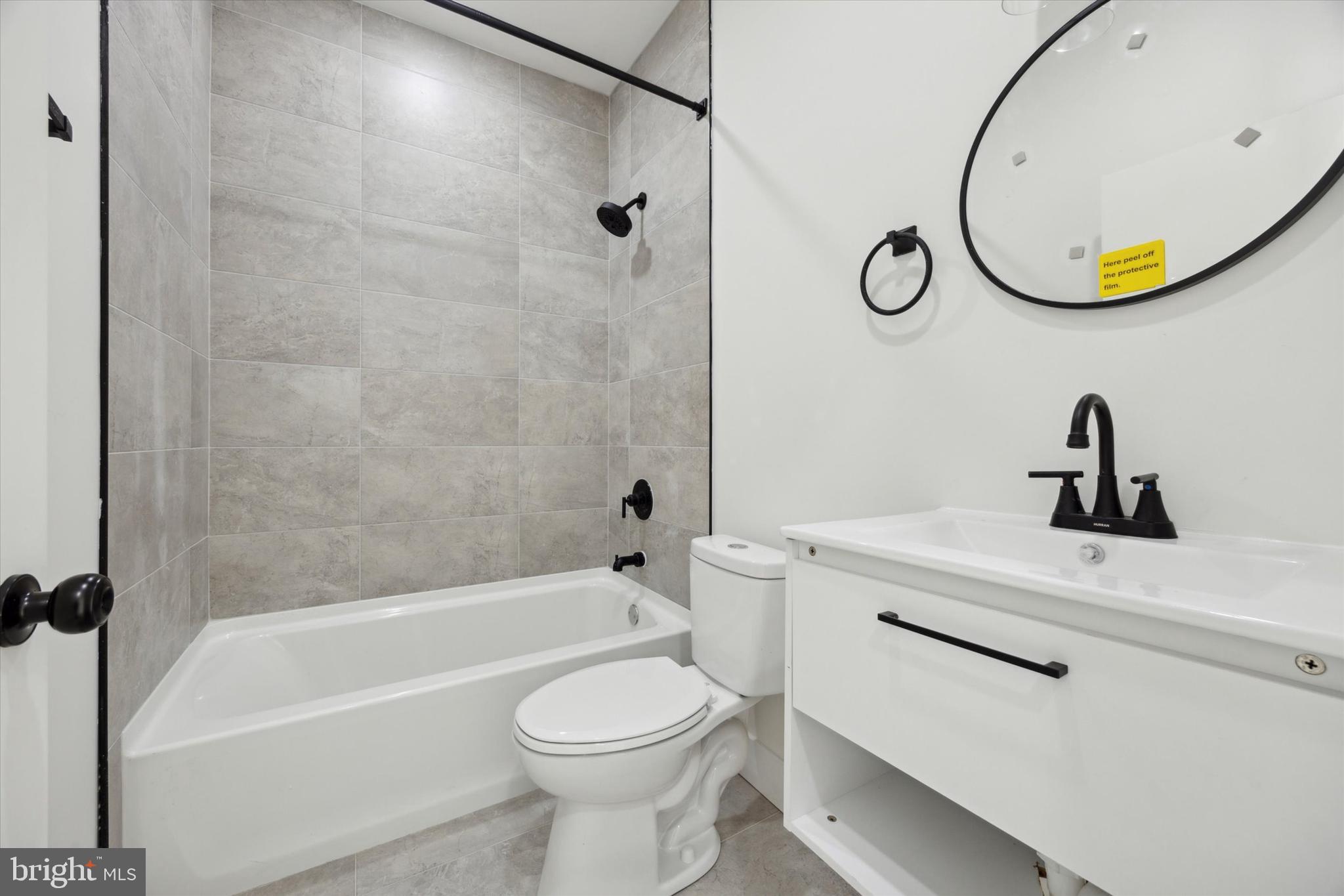 5325 Baltimore Avenue, Unit 2 Philadelphia, PA 19143 - Photo 17 of 25 a bathroom with a sink a toilet and a mirror