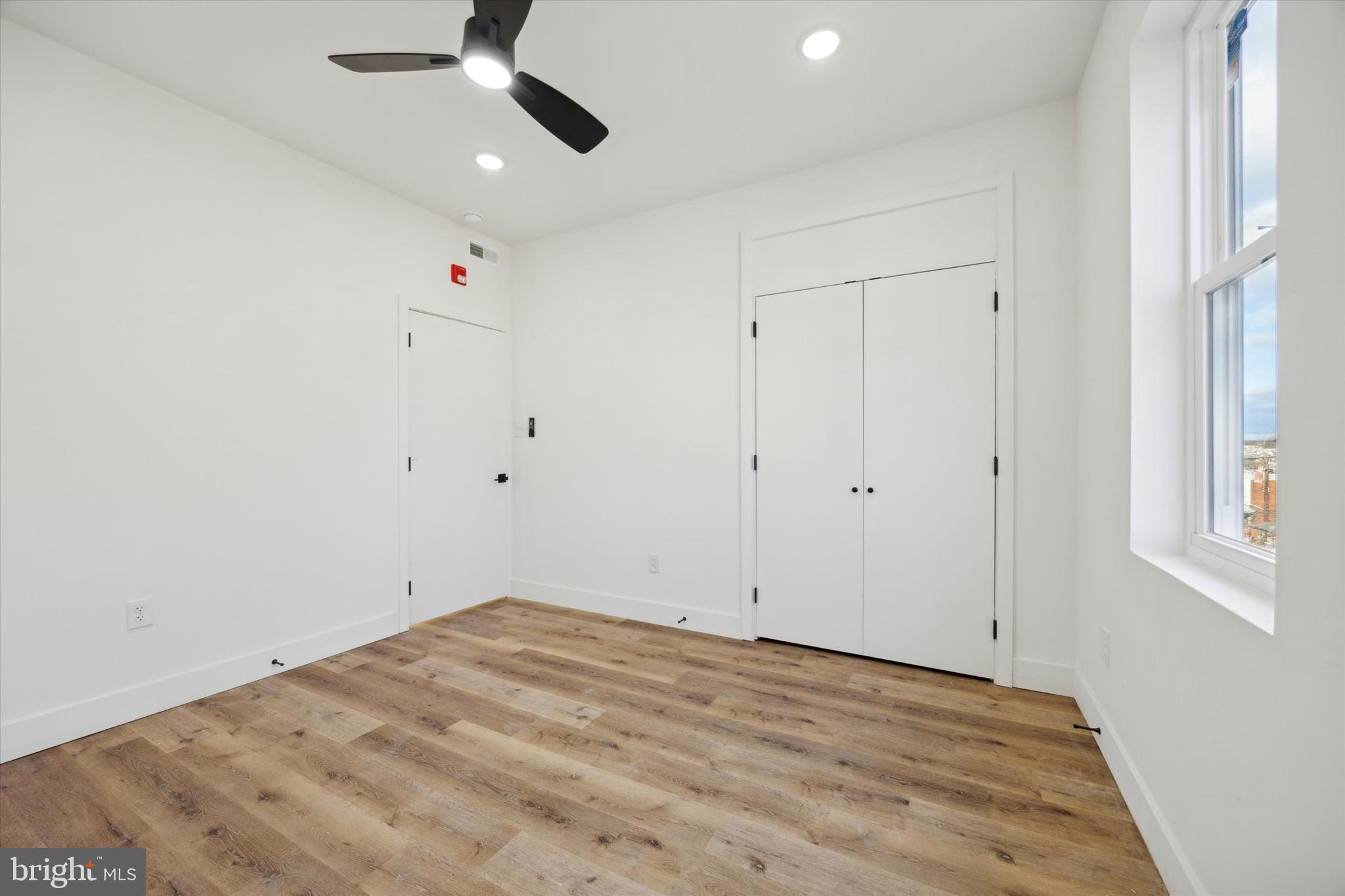 5325 Baltimore Avenue, Unit 2 Philadelphia, PA 19143 - Photo 23 of 25 an empty room with a ceiling fan and window