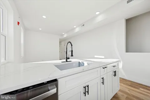 a room with a sink and wooden floor