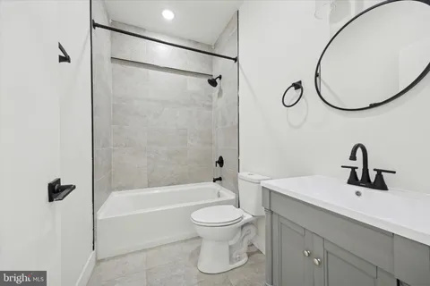 a bathroom with a toilet sink and a mirror