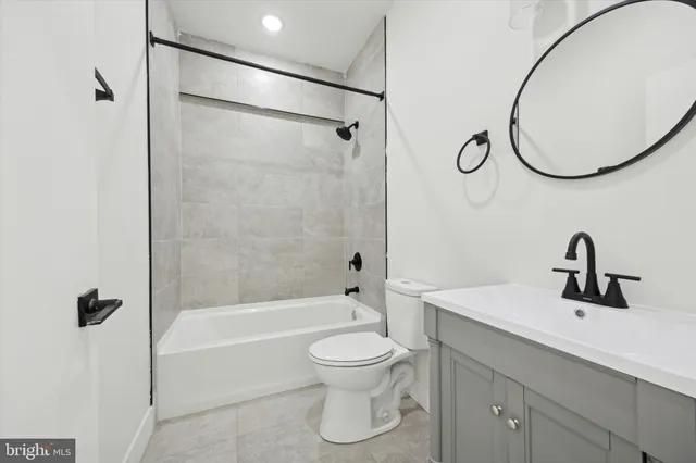 a bathroom with a toilet sink and a mirror