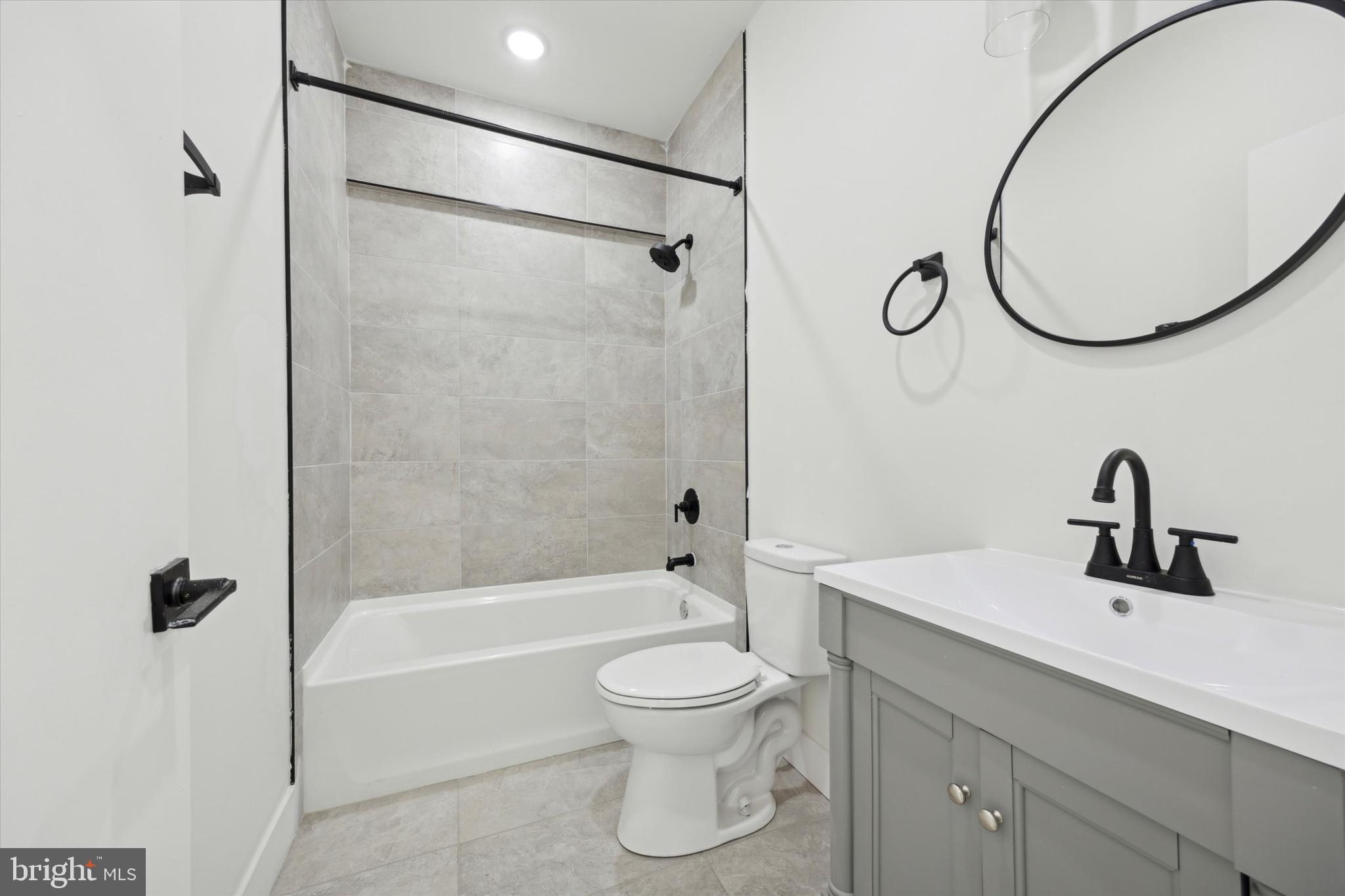 5325 Baltimore Avenue, Unit 2 Philadelphia, PA 19143 - Photo 8 of 25 a bathroom with a toilet sink and a mirror