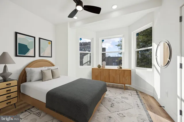 a bedroom with a large bed and a chandelier