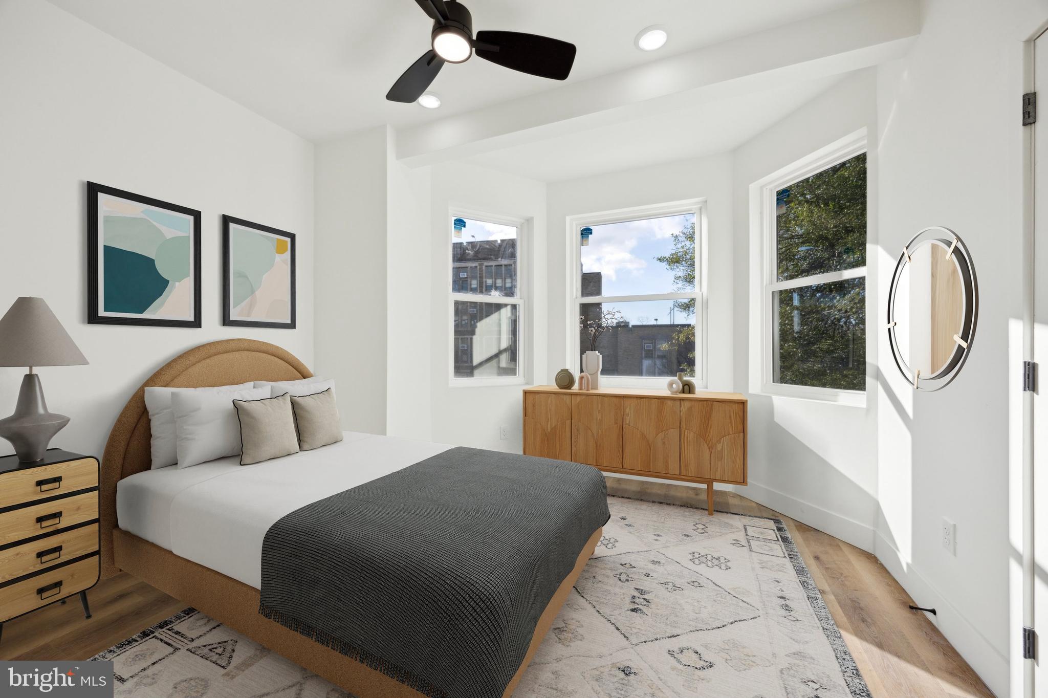 5325 Baltimore Avenue, Unit 2 Philadelphia, PA 19143 - Photo 9 of 25 a bedroom with a large bed and a chandelier