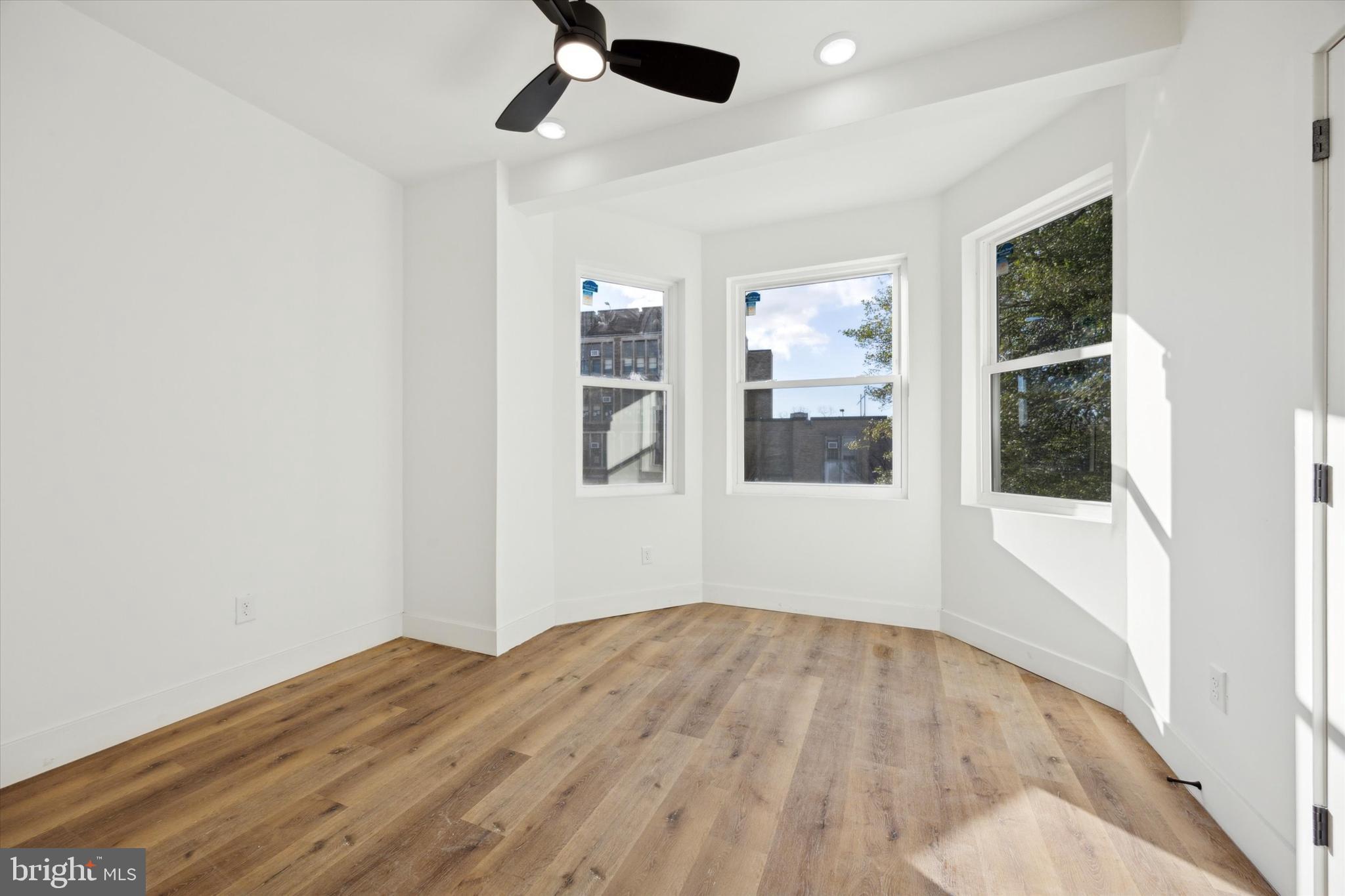 5325 Baltimore Avenue, Unit 2 Philadelphia, PA 19143 - Photo 10 of 25 a view of empty room with wooden floor and windows