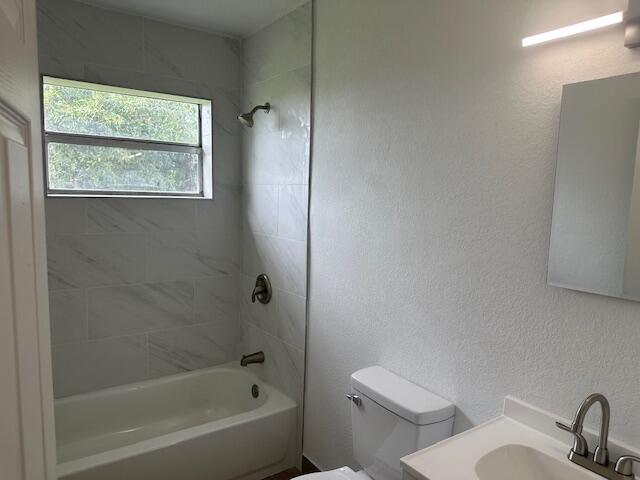 491 West Jordan Boulevard Pahokee, FL 33476 - Photo 3 of 10 a white toilet sitting next to a bath tub