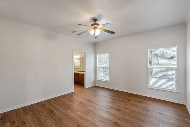a kitchen with wooden cabinets a sink a stove a refrigerator and blue cabinets