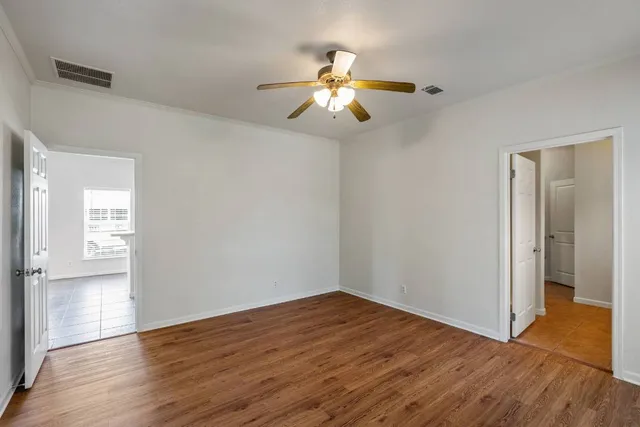 wooden floor in an empty room with a window