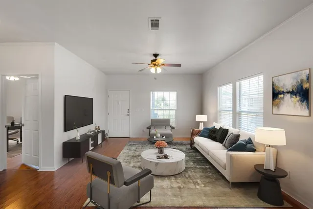 a living room with furniture and a flat screen tv
