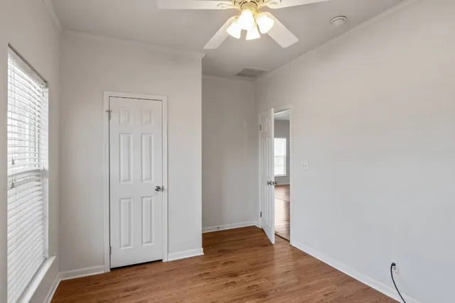 wooden floor in an empty room with a window