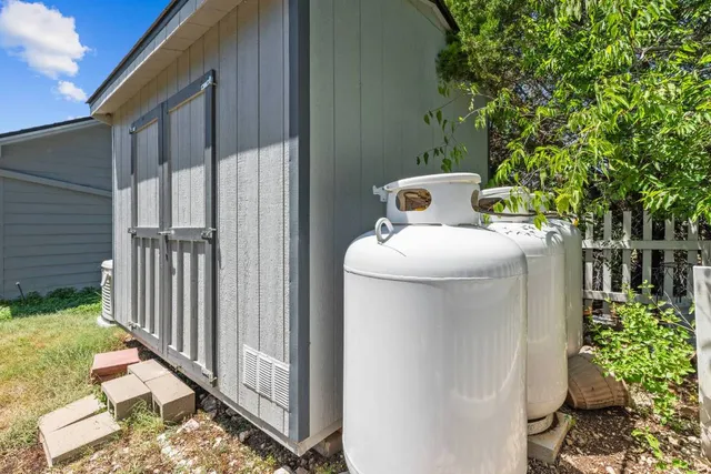 a backyard of a house with table and chairs