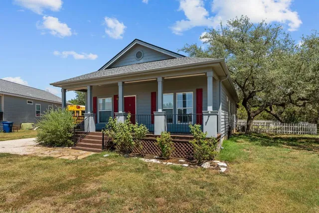 a view of a swimming pool with a yard and sitting area