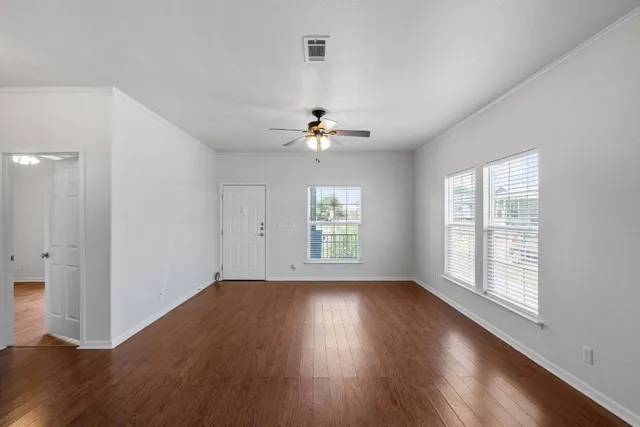 wooden floor in an empty room with a window
