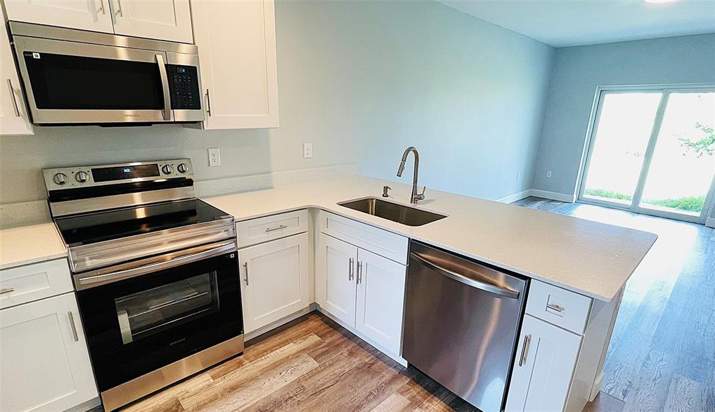 12258 Henley Avenue, Unit B Port Charlotte, FL 33981 - Photo 12 of 39 a kitchen with a stove and a microwave