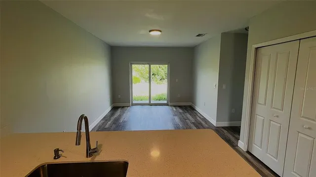 a view of a sink in a hall with a window
