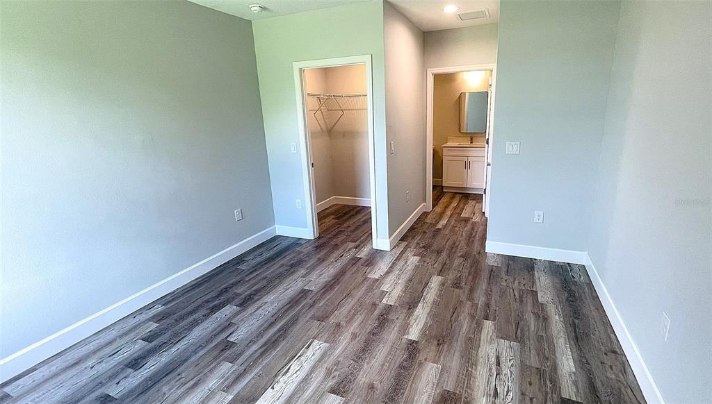 12258 Henley Avenue, Unit B Port Charlotte, FL 33981 - Photo 17 of 39 a view of a room with wooden floor and bench