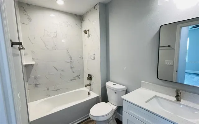 a bathroom with a toilet and a bath tub