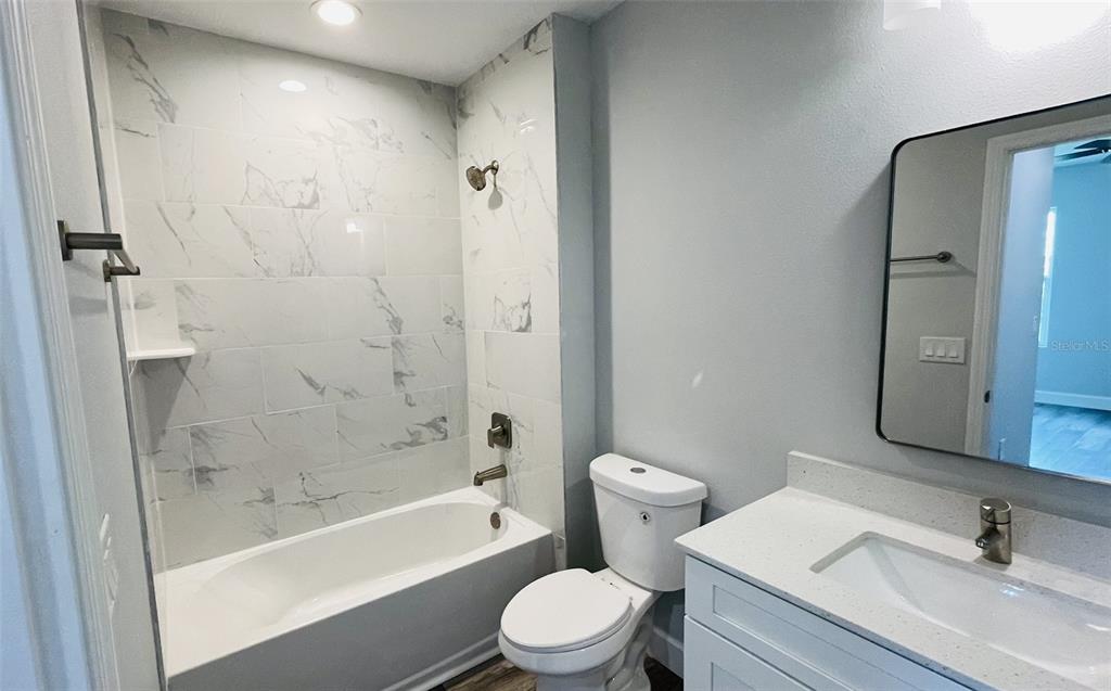 12258 Henley Avenue, Unit B Port Charlotte, FL 33981 - Photo 19 of 39 a bathroom with a sink a toilet and a bathtub