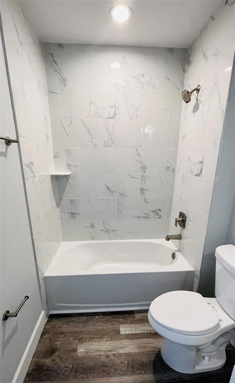 12258 Henley Avenue, Unit B Port Charlotte, FL 33981 - Photo 20 of 39 a bathroom with a toilet and a bath tub