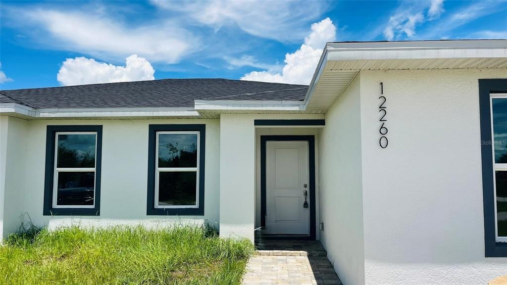 12258 Henley Avenue, Unit B Port Charlotte, FL 33981 - Photo 2 of 39 front view of a house with a window