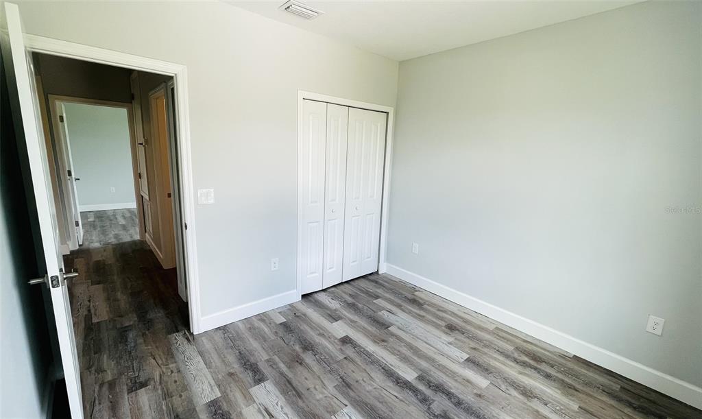 12258 Henley Avenue, Unit B Port Charlotte, FL 33981 - Photo 23 of 39 a view of a small space with wooden floor and a sink