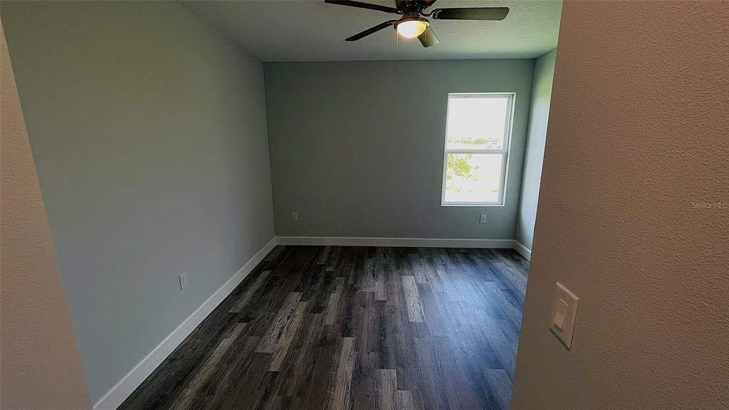 12258 Henley Avenue, Unit B Port Charlotte, FL 33981 - Photo 25 of 39 a view of a room with wooden floor and window