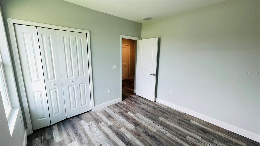 12258 Henley Avenue, Unit B Port Charlotte, FL 33981 - Photo 28 of 39 a view of a livingroom with wooden floor