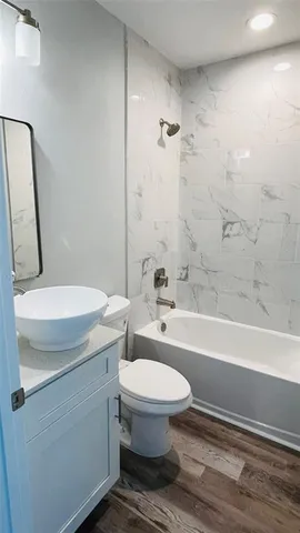 a bathroom with a sink a toilet and bathtub