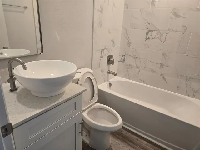 a bathroom with a toilet a sink and bathtub