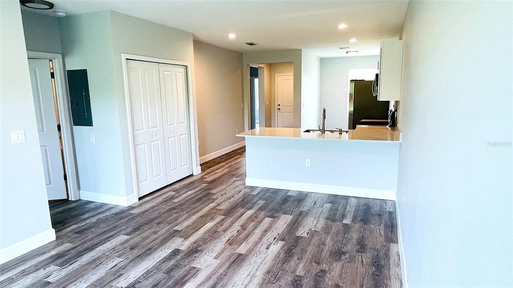 12258 Henley Avenue, Unit B Port Charlotte, FL 33981 - Photo 3 of 39 a view of a hallway with wooden floor and staircase