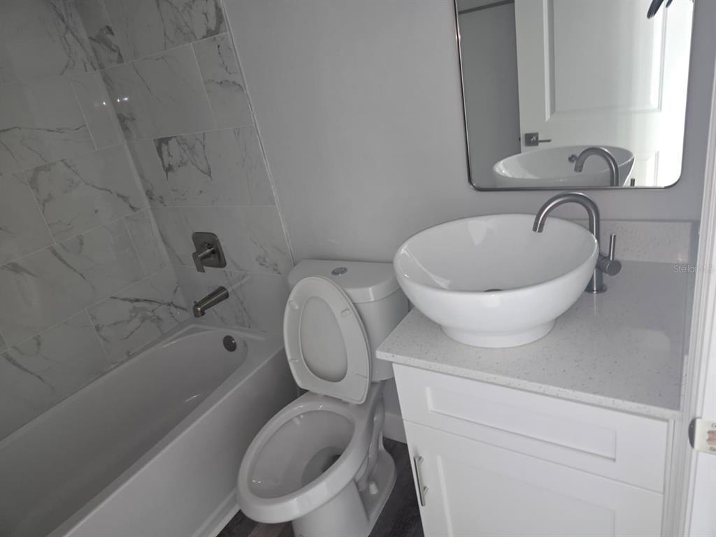 12258 Henley Avenue, Unit B Port Charlotte, FL 33981 - Photo 31 of 39 a bathroom with a toilet a sink and bathtub