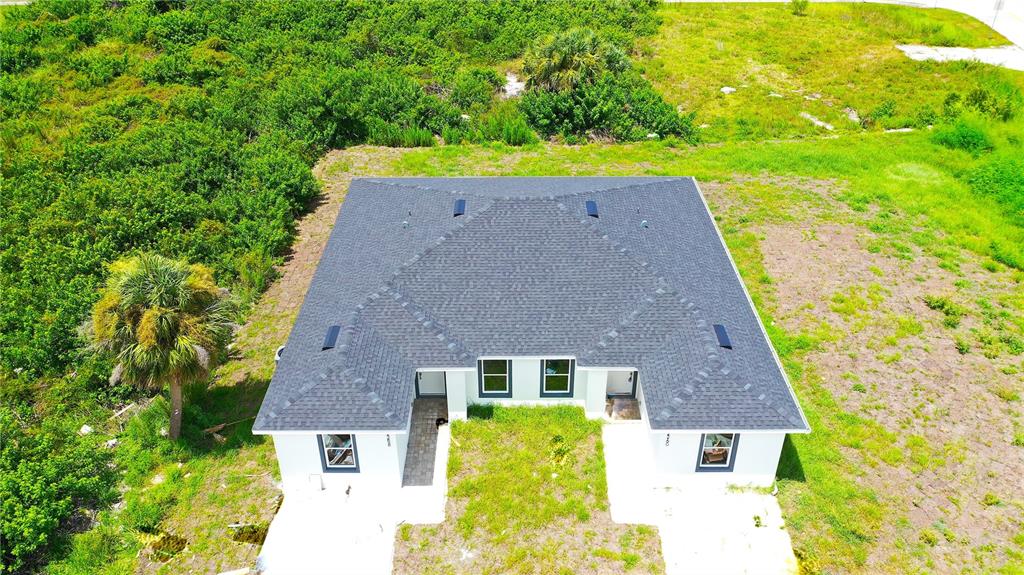 12258 Henley Avenue, Unit B Port Charlotte, FL 33981 - Photo 33 of 39 front view of a house with a yard