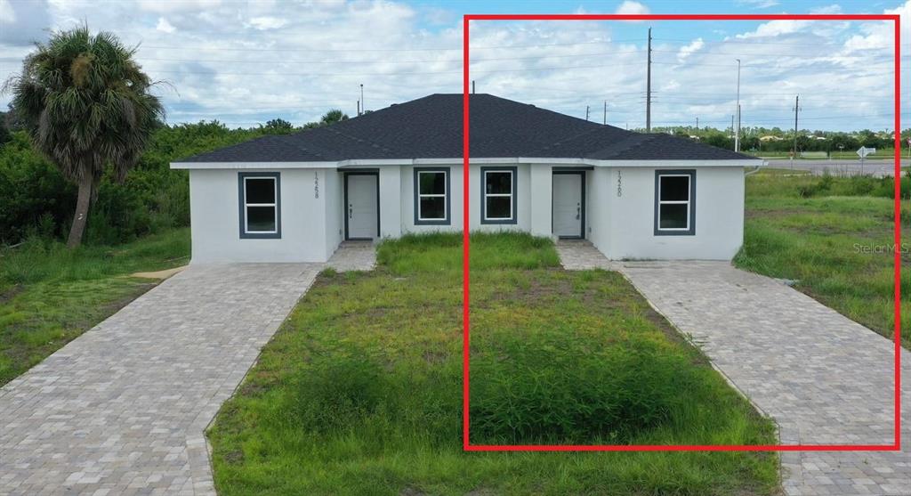 12258 Henley Avenue, Unit B Port Charlotte, FL 33981 - Photo 39 of 39 a view of a yard in front of a house