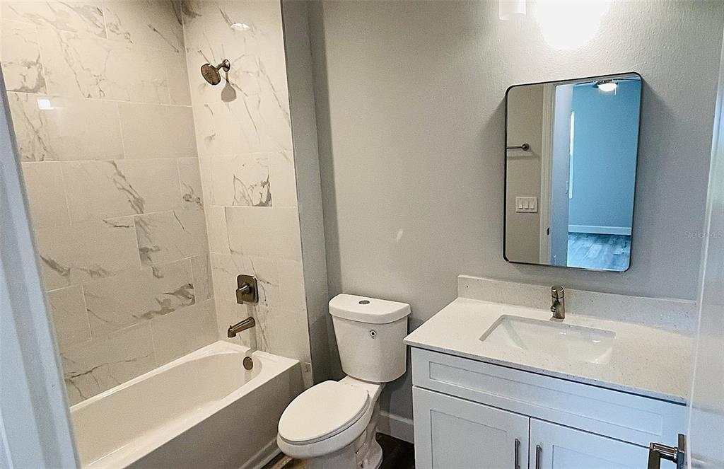 12258 Henley Avenue, Unit B Port Charlotte, FL 33981 - Photo 4 of 39 a bathroom with a sink toilet and shower