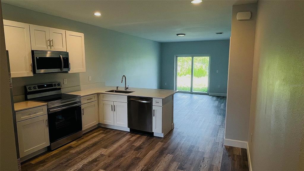 12258 Henley Avenue, Unit B Port Charlotte, FL 33981 - Photo 8 of 39 a kitchen with a sink and a stove top oven