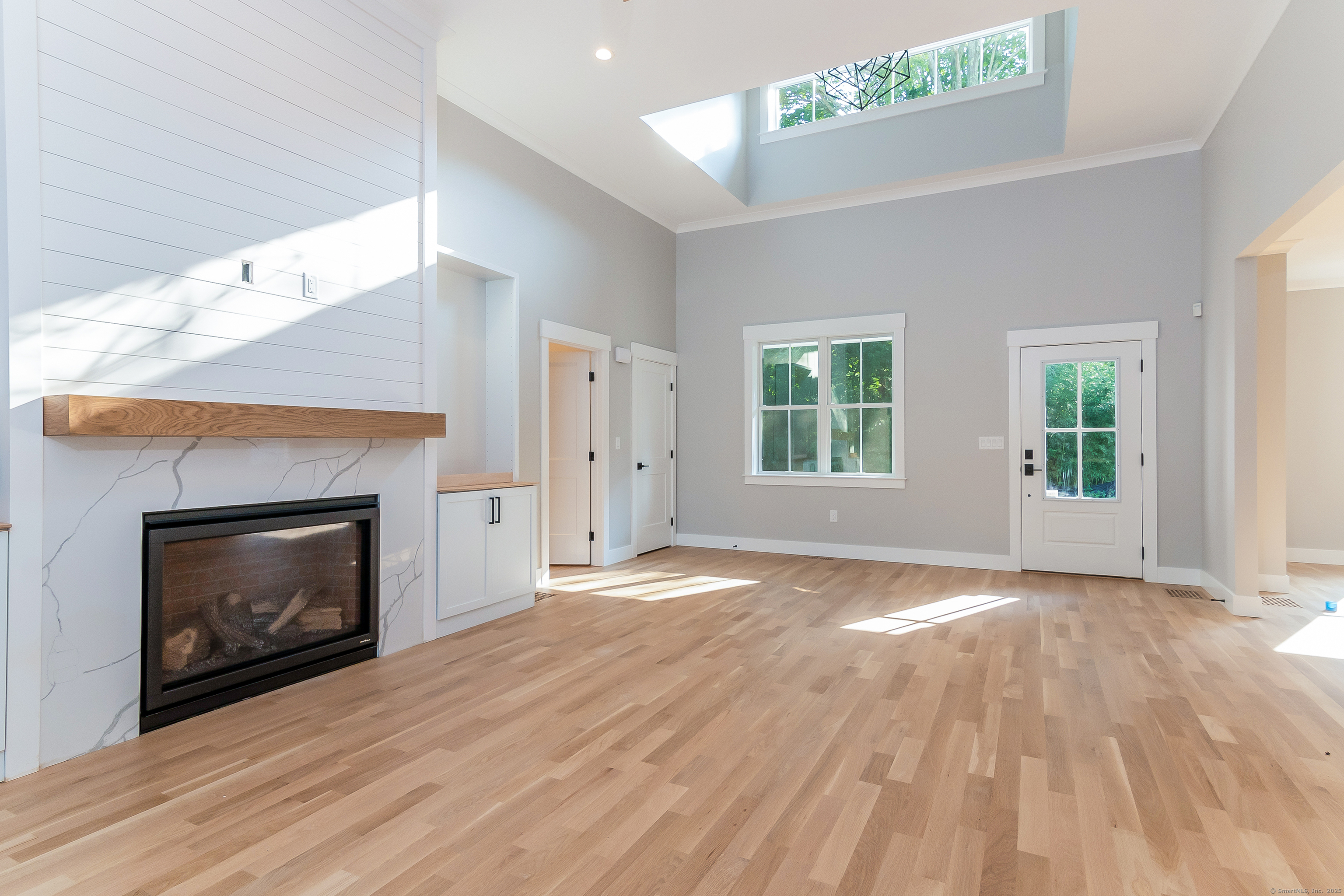11 Buttonball Road Old Lyme, CT 06371 - Photo 23 of 38 a view of an empty room with wooden floor fireplace and a window