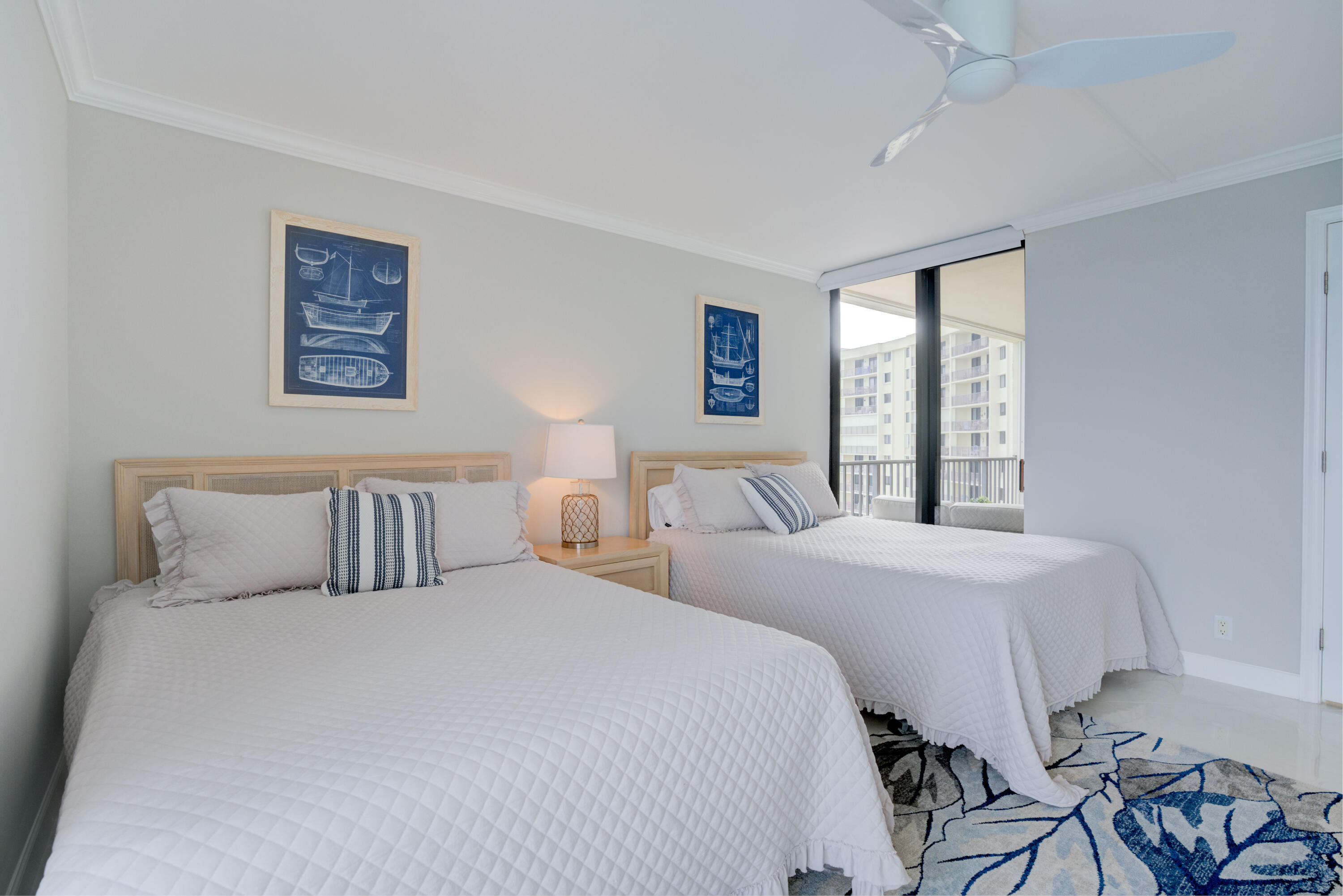 200 Ocean Trail Way, Unit 910 Jupiter, FL 33477 - Photo 6 of 16 a bedroom with two beds and a window