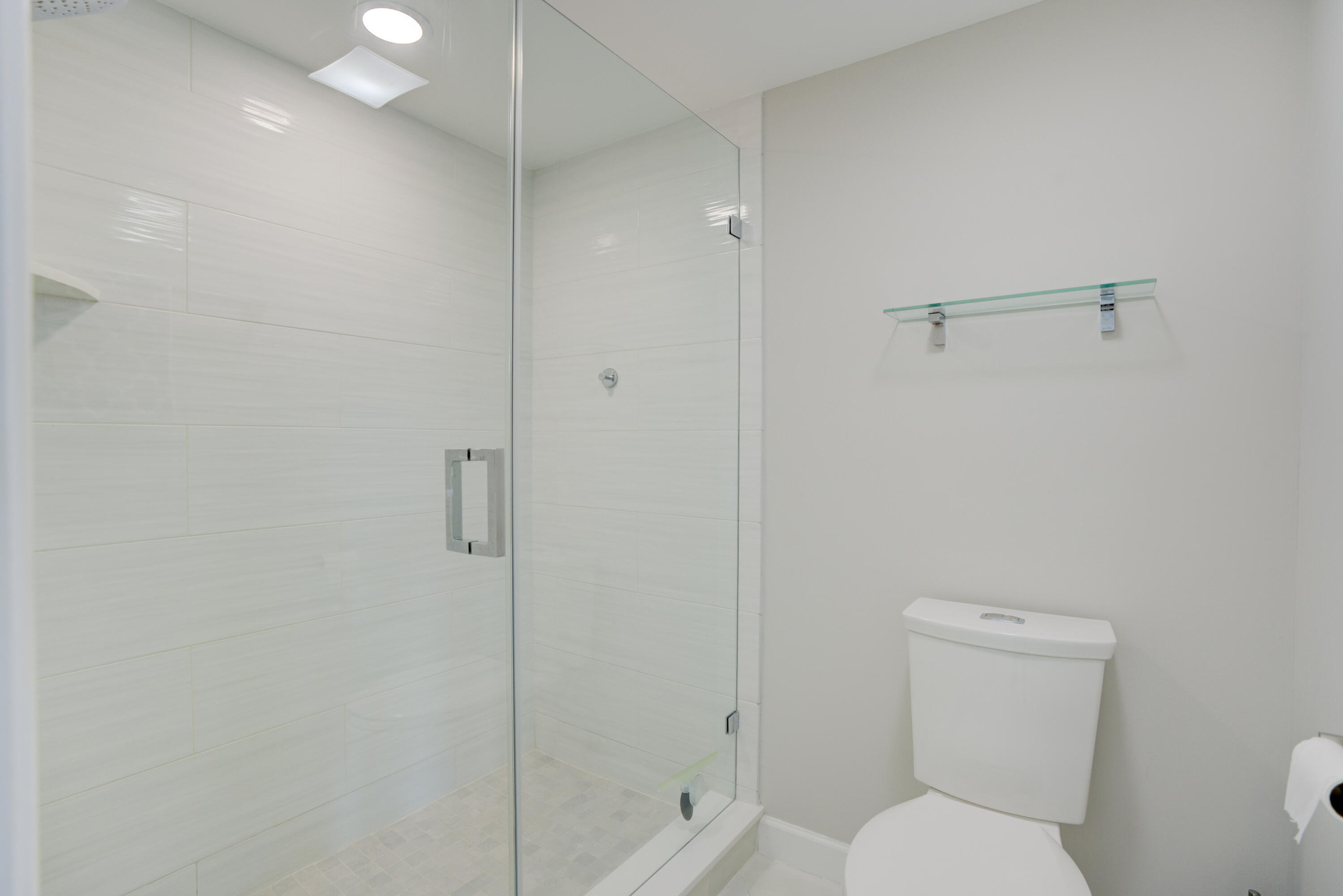 200 Ocean Trail Way, Unit 910 Jupiter, FL 33477 - Photo 7 of 16 a bathroom with a toilet and shower