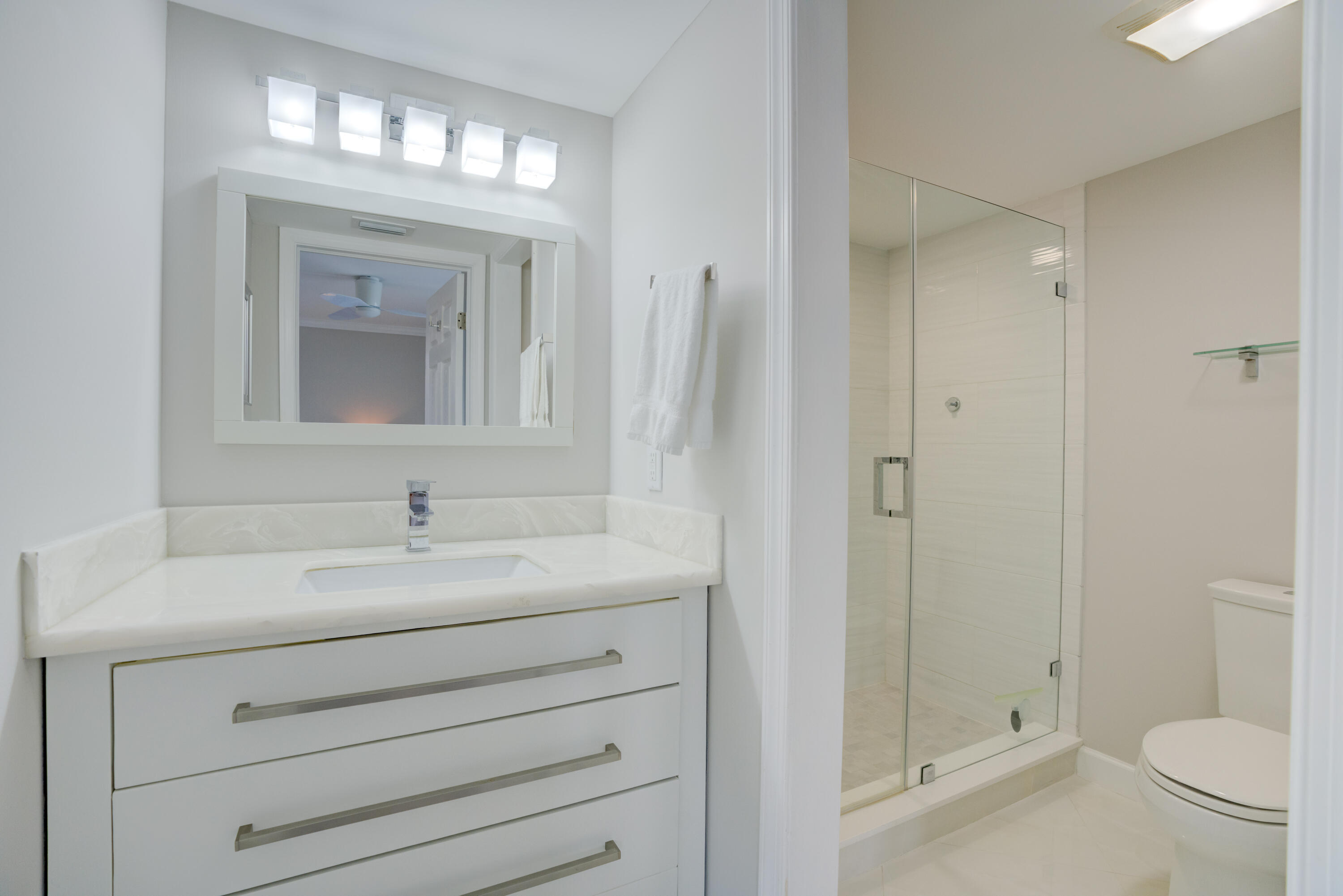 200 Ocean Trail Way, Unit 910 Jupiter, FL 33477 - Photo 8 of 16 a bathroom with a sink a toilet and shower